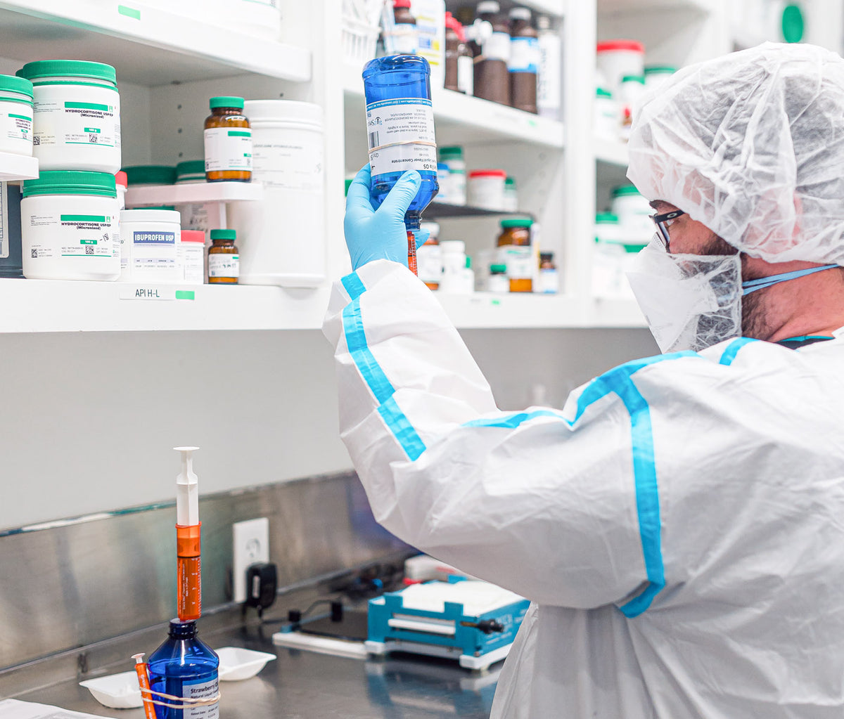 Licensed pharmacist measuring a flavor concentrate to compound a pet medication at Thornhill's Pharmacy